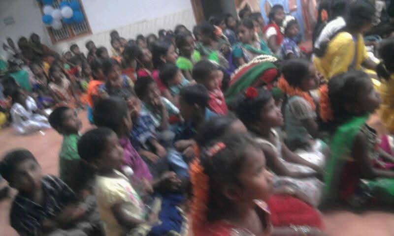 Hall full of children seated together at a ministry gathering