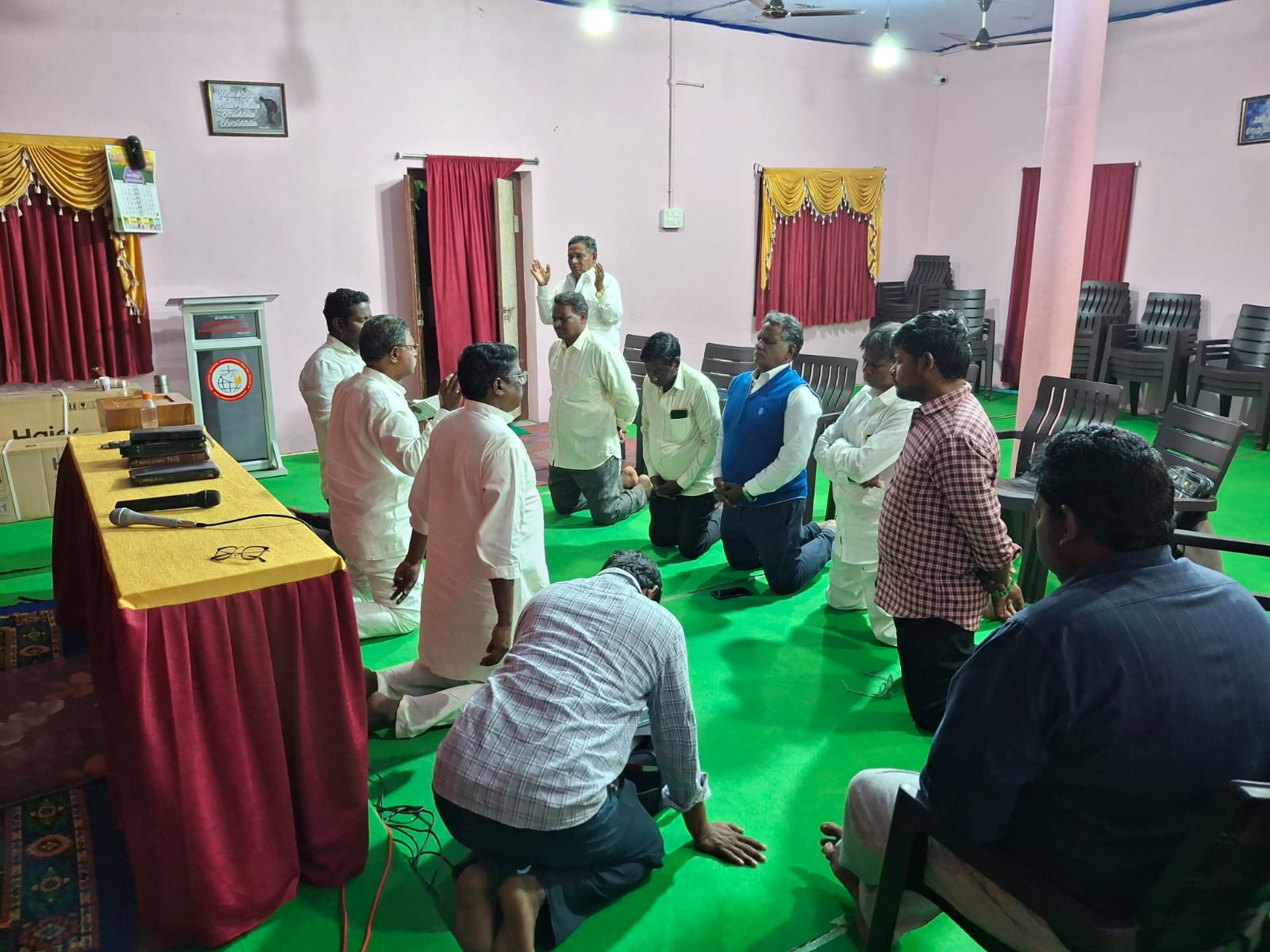 Congregation kneeling in worship and prayer