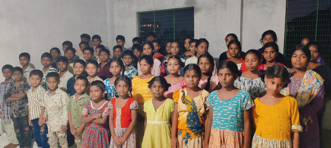 Large group of children gathered together before a meal