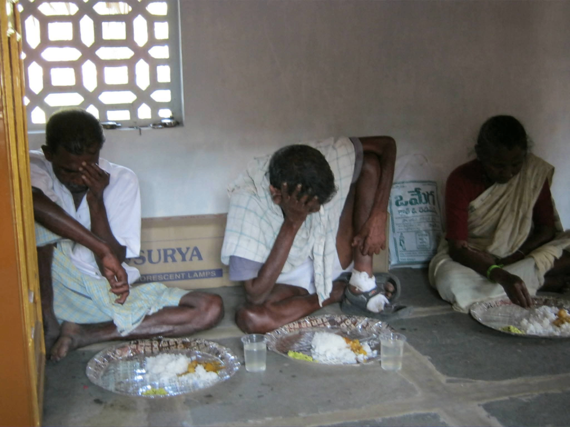 Leprosy patients receiving a hot meal seated together