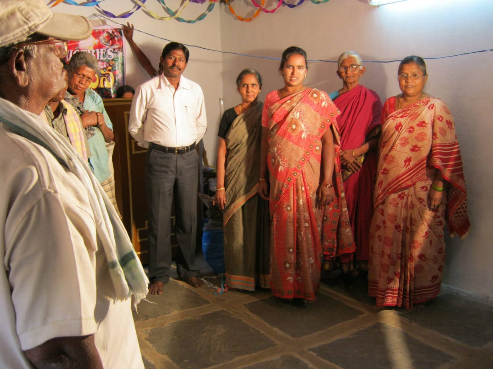 Widows and families gathered in fellowship with ministry leaders
